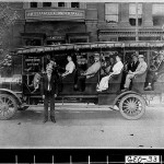 Photograph of open passenger bus in front of J. William Lee, Undertaker & Livery, Georgia, ca. 1914-1915