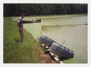 Photograph of Contractor Accessing Flood Damage at Wastewater Treatment Pond, Byron, Peach County, Georgia, 1994 July 8