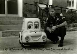 Cpl. K.R. Porter with RC Robot Patrol Car. City of Savannah, Public Information Office. Courtesy of City of Savannah, Research Library & Municipal Archives.