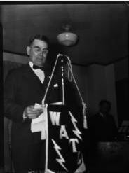 Radio announcer introducing a high school glee club on WATL, Atlanta, Georgia, circa late 1930s or early 1940s. David A. Lennox, Jr. Photographs, Special Collections and Archives, Georgia State University Library.