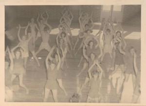 Photograph of high school girls performing calisthenics in a physical education class at Screven County High School, Sylvania, Georgia, 1951. Screven-Jenkins Regional Library System Collection, Screven-Jenkins Regional Library System.