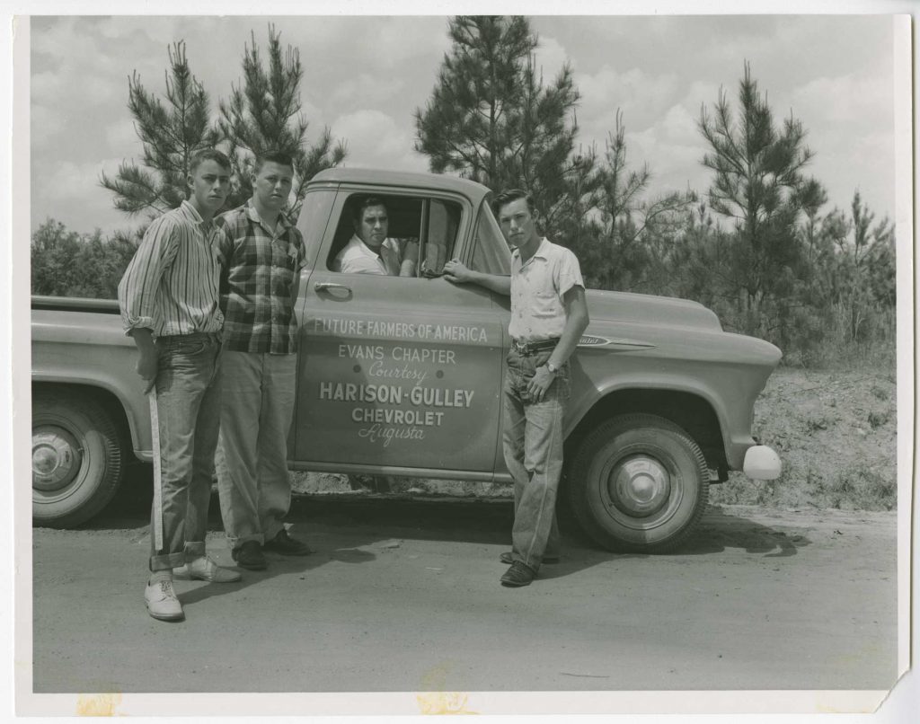 Photograph of Horace Fitzgerald, Larry Edmond, John Devette, Clever Youngblood with a Future Farmers of America truck, Columbia County, Georgia, 1957 May