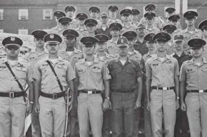 Page 68 from the 1975 edition of the University of North Georgia Cyclops yearbook. It is a photograph of the 1975 band company, and features a group of men standing for a group portrait. They are all dressed in military uniforms.